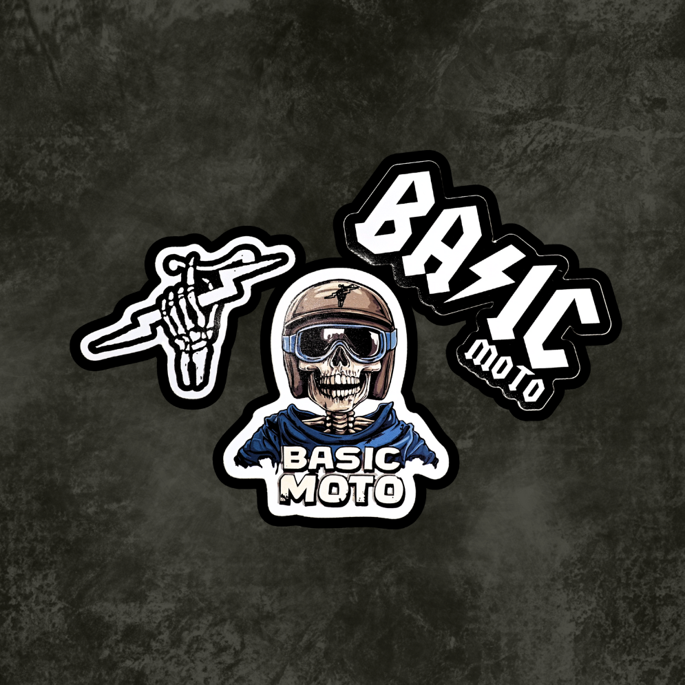 Three 'Basic Moto' stickers on a dark textured background